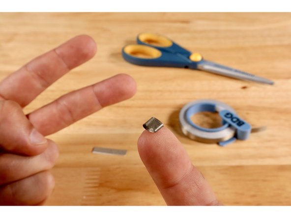 Cut two small pieces of Maker Tape and roll them into two sticky-side-out tape loops.