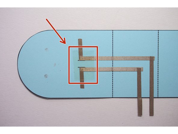 On the inside, add a piece of regular tape over the slits, making sure it covers the Maker Tape