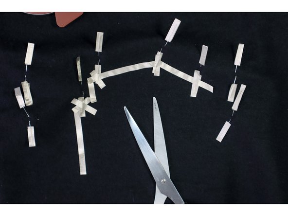 Start in the location where you'd like to place the battery, and connect the negative legs together with a long piece of maker tape.