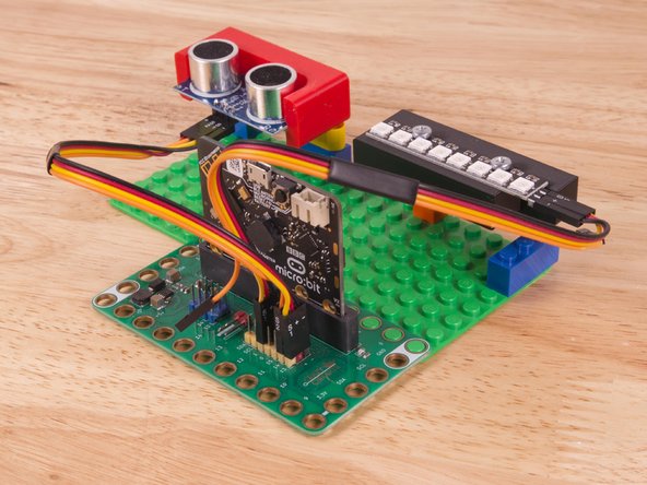 Plug the three-wire connector of the Crazy Circuits Ribbon Cable into the row with Pin 13 on the Bit Board. The wire colors should match the pin header colors, with S1 (yellow) going to the yellow pin.