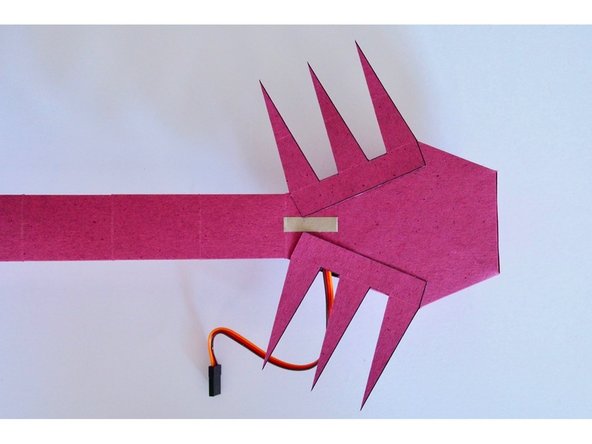 Glue the legs to the bottom of ScorpioBot's body.