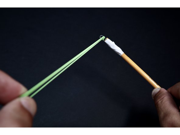 Tightly tape the paperclip to your pencil leaving about 1/4&quot;-1/2&quot; hanging off the end. Tight wraps are important here because the paperclip will be under considerable tension when launching.