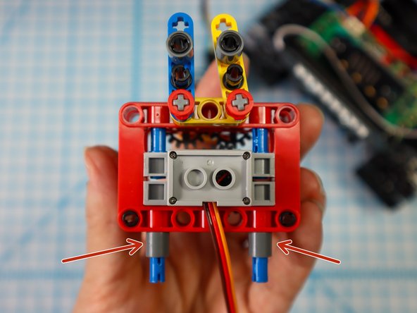 Place single beams on each of the pins.