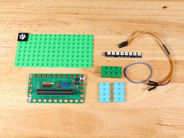 To connect the NeoPixel Strip to the project you will need a Crazy Circuits Ribbon Cable, a rubber band, and some LEGO bricks.