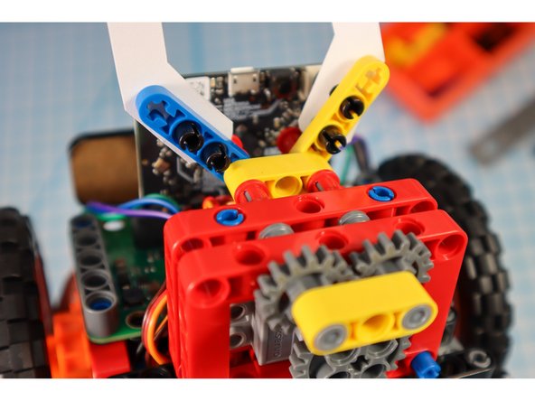 Unpin the pins from the half beams and use them to attach the arms as shown.