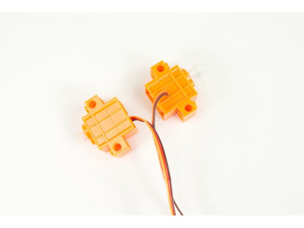 It's servo time! Make note of the orientation of the servos. We need the shafts to line up so one of the servos will be mirrored.