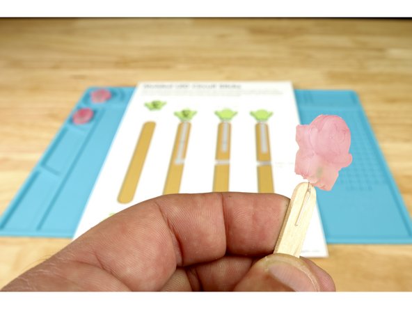 Place the LED over the end of your popsicle stick so that the short positive leg is in front  (photo 2) and the long positive leg is on the opposite side of the stick (photo 3).