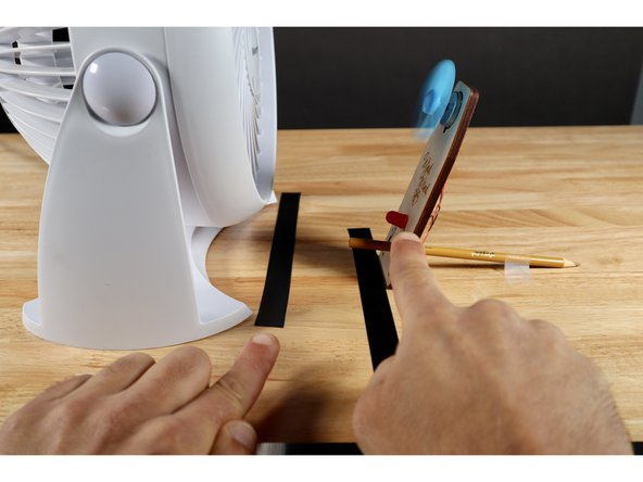 Now slowly back the fan up while observing the LED until no discernible light is being produced. Mark the fan's position with a piece of tape.