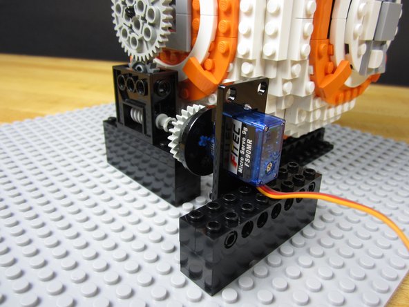 We connected two 1x8 Technic bricks together and then attached the servo to those pieces.