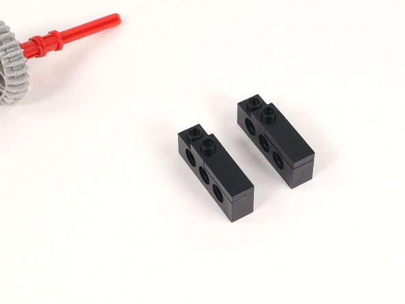 Add a 1x1 plate to each 1x4 brick with holes adjacent to the 1x2 plate added in the previous step.