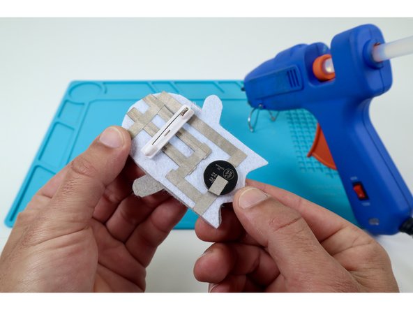 Stick that safety pin where shown in photo 2. 