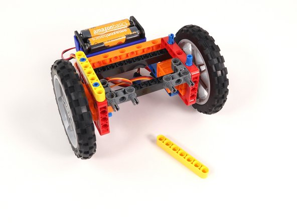 Add a yellow beam onto the blue pins on each side of the Rover