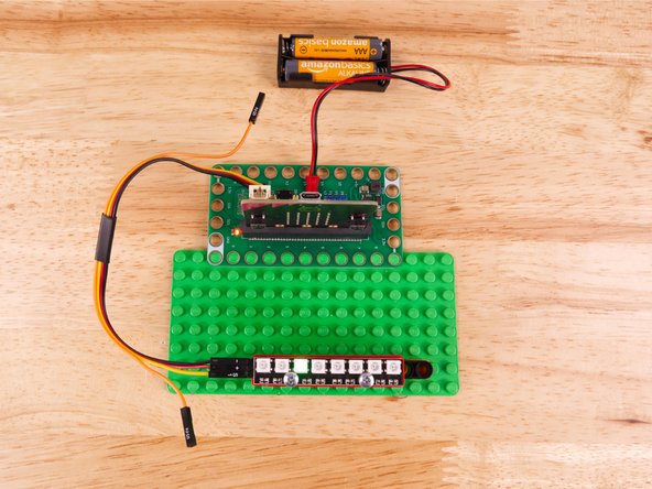 So let's get connected! If you turn the NeoPixel Strip over you'll see labels for the three pins. You should see IN, VCC, and GND.