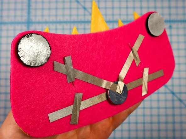 Then, peel the paper backing off of the other side and stick the design to the hat.