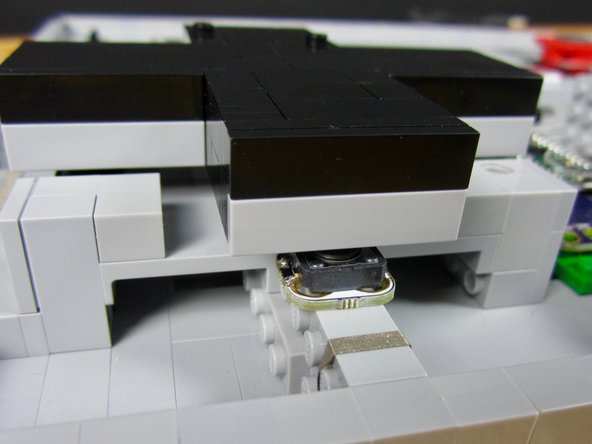 Position and tape down the four D pad buttons.