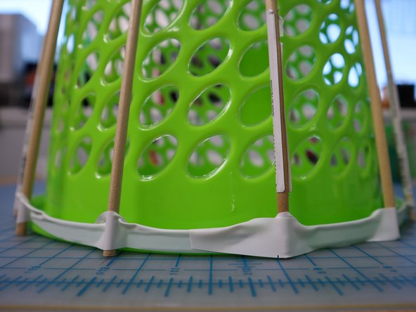 I used a long piece of electric tape and positioned each dowel as I spun the basket around, but you could also use individual pieces of tape.