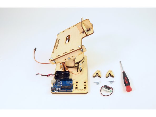 Gather the two wooden brackets pictured, two (8-32 3/4") screws, two (8-32) nuts,  the wired voltmeter and the Solar Tracker assembly from the previous step.