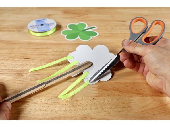 Squeeze a bead of hot glue along the two lowest curves of the shamrock shape on the back side of the front template.