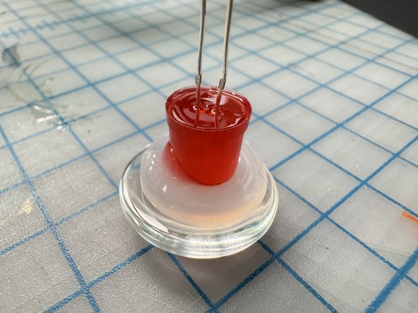 Wait until the glue is almost cool, then stick the LED to it.