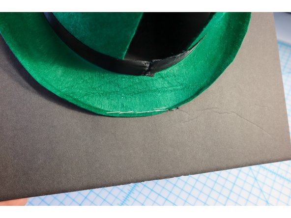 Staple the hat's brim to the foam core to make a hinge as shown. (If you're using a cardboard box, cut off all but one of the flaps and staple the remaining flap to the foam core.)