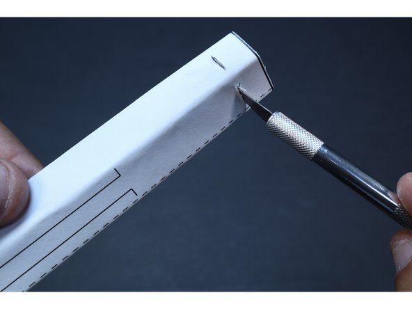 With proper supervision, use a ruler and an Exacto Knife to cut the two small corresponding slits shown in the photos at left. Make multiple passes with the blade and take care to only cut the length of line/slit on the template. You will thread two small sections of Maker Tape through these slits in the coming steps. 