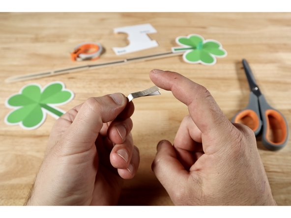 The fold now creates a long and short section. Measure, cut, peel, and stick a piece of Maker Tape that is the length of the longer section ONTO that same long section.