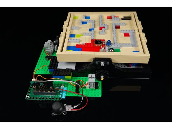 Add the Bit Board to your project. You'll want it positioned between the two servos so the wires can reach to plug in the servo motors.