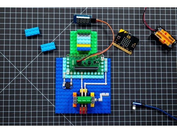 Add the 7 Segment Display by connecting jumper wires to the pins and then plugging them into the correct pins on the Bit Board.