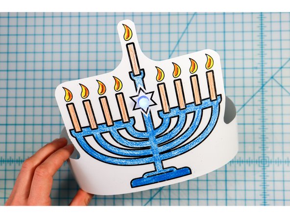 Cut out the side strips and tape them to the hat with the slits facing up on one side and down on the other.