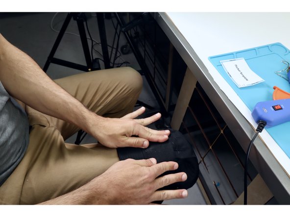 Use the template to see where to place hot glue and then flip over/press into place. Make sure that the only completely glueless side is facing UPWARD to ward the top of the hat and that there is a gap in the glue  at the bottom left corner when pressed into place.