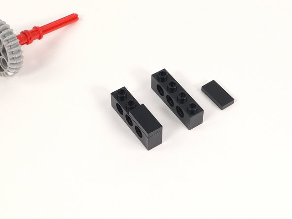 Add a 1x2 tile to the last two studs of a 1x4 brick with holes. You will need two of these.
