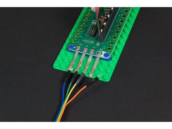 We recommend laying down your Maker Tape connection from the Bit Board, and then wrapping it around the edge to the bottom of the LEGO baseplate.