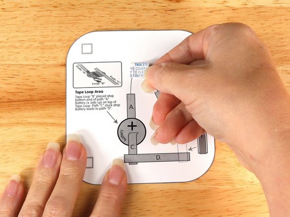 Add a piece of double-sided foam tape to the center of the bottom layer.