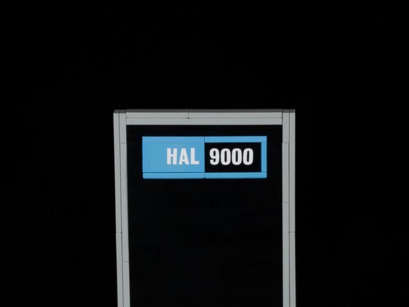 We added a little detail with our vinyl cutter. Using white vinyl we cut out &quot;HAL 9000&quot; small enough to attach to the blue LEGO plates on the top of HAL.