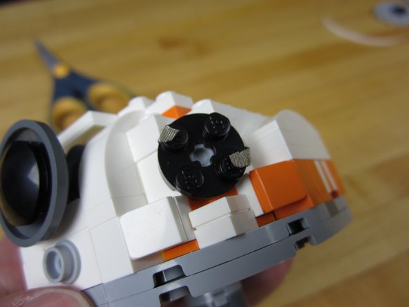 Push your LED holder (2x2 Round Plate) into place.