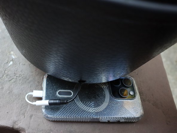 Place speakers inside the cauldron and connect a phone.