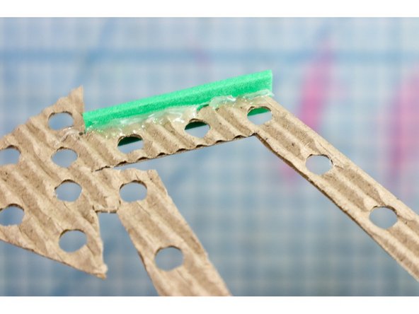 Line the outer edge with .5 inch strips of craft foam. Cardboard strips would also work.