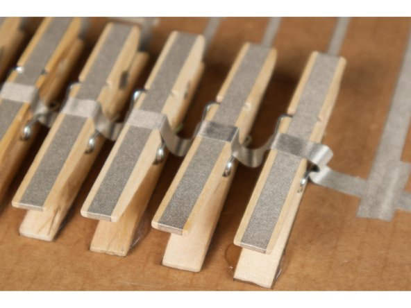 Run one long piece of Maker Tape across the top of the clothespins to the ground connection on the right side.