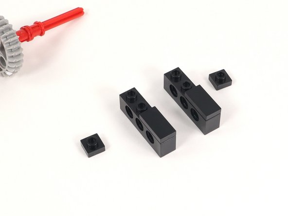 Add a 1x1 plate to each 1x4 brick with holes adjacent to the 1x2 plate added in the previous step.