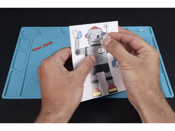 Each vertical column of dots is a place to feed a single LEDs legs through. Feed the legs of each of the LEDs through their pair of holes from the front. Make sure to feed the short legs through the topmost holes and the longer legs through the lower holes.