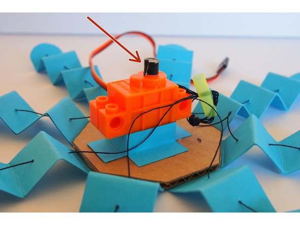 Since straws come in all different sizes, it may be too big. If that's the case, put a very small piece of tape around the servo shaft to increase its diameter
