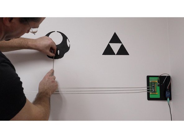 Since we have a laser cutter in our workshop we cut out a small mounting plate that we could stick to the wall. It's also quite easy to just use double sided tape and stick the LEGO plate to a wall as well. We used some self sticking velco in case we ever wanted to move the mounting plate or change things up.