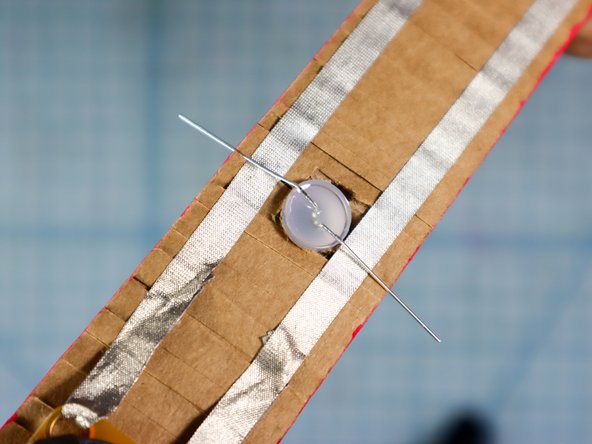 Now that you're certain that you know which way to connect it, place the LED through the hole.