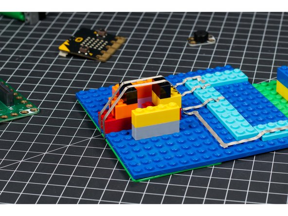 The trickiest part of the build is adding the crank and the tape below it. You need to add the tape so it is taut, and then add the cylinder on top of it, pressing against the tape.