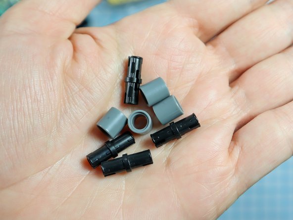 Connect each LEGO pin to a LEGO round beam as shown.