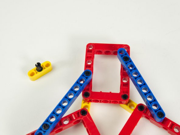 Place a black pin into the middle of a yellow 3 hole beam.