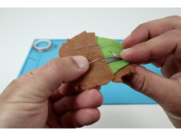 Peel and stick half of a single piece to a single LED leg as shown at left and then fold it back onto itself. This will result in the LED leg being sandwiched between the two layers.