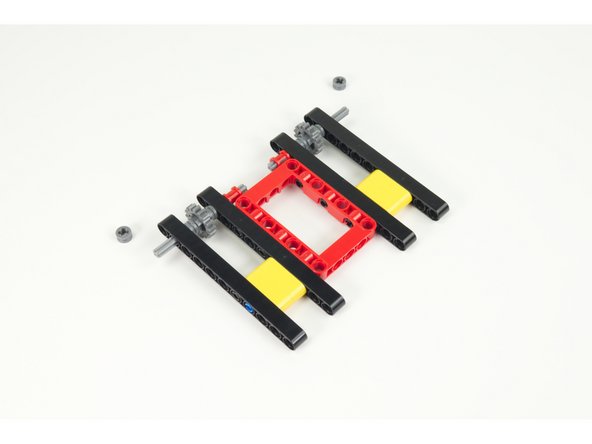 Add the outside beams as shown, then put the half-size bushing back in place on the front axles.