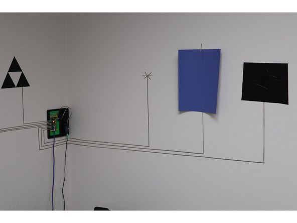 When you'll want to do is run tape to set points on the wall, lined up nice and level. Use sheets of paper as place holders for spacing everything out.