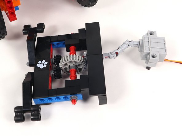 Connect the servo shaft to the universal joint on the Claw with the black pins and the wires facing down.